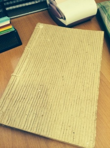 Old notebook made of recycled paper with corrugated cover